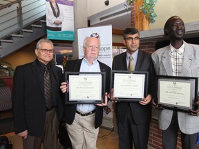Dr. Michael Dufresne, left, announces  the Seeds4Hope grant recipients Dr. William Crosby, Dr. Maher El-Masri, and Dr. Alioune Ngom during a presentation at the Windsor Regional Cancer Centre on October 29, 2014. (JASON KRYK/The Windsor Star)