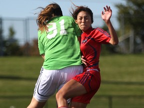 Windsor goalie, Krystin Lawrence, left, collides with Brock's Ashley Altamirano during OUA woman's soccer at Alumni Field, Saturday, Oct. 11, 2014.  WIndsor defeated Brock 5-1. (DAX MELMER/The Windsor Star)