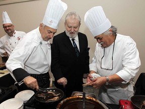 Thom Racovitis, centre,  chats with chefs Vincenzo Del Duca and Glenn Blommesttein, right at the A Toast to Thom gala at the St. Clair Centre for the Arts in Windsor on Friday, October 10, 2014. Members of the Windsor Chefs Guild, Windsor Regional Hospital, St. Clair College and past employees planned the event as a tribute to the owner of the former Tunnel BBQ.                     (TYLER BROWNBRIDGE/The Windsor Star)
