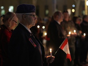 WINDSOR, ONT.: (10/26/14) -- Retired Warrant Officer Ruth Rusk stands in a candle light vigil at Windsor's cenotaph Sunday, Oct. 26. The vigil was held in memory of Cpl. Nathan Cirillo and Warrant Officer Patrice Vincent, two soldiers killed in attacks on Canadian soil last week. (RICK DAWES/The Windsor Star)