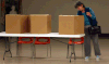 Voter Janice Bondy gathers her ballot at advance polling station at Most Precious Blood Church hall on Meldrum, Friday October 16, 2014. Voter turnout was light, but steady around 4 p.m. (NICK BRANCACCIO/The Windsor Star)