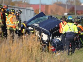 Emergency crews work at the scene of an accident along an on-ramp to EC Row Expressway and Lauzon Parkway on Sunday, Oct. 26, 2014. (DAX MELMER/The Windsor Star)