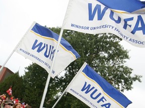 Windsor University Faculty Association (WUFA) flags at a march on Labour Day, Sept. 1, 2014. (Dax Melmer / The Windsor Star)