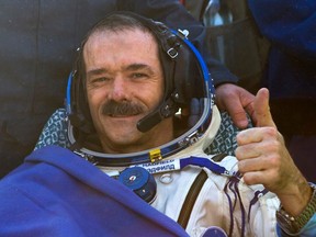 Canadian astronaut Chris Hadfield gestures after the Russian Soyuz space capsule landed some 150 kilometres southeast of the town of Dzhezkazgan in central Kazakhstan, Tuesday, May 14, 2013. The Soyuz space capsule carrying a three-man crew returning from a five-month mission to the International Space Station landed safely on the steppes of Kazakhstan. (Sergei Remezov / Associated Press /  Pool)