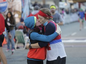 Maddy LaFave kisses her boyfriend Nathan Wise after he finished his first half-marathon last Sunday in Detroit. (Ryan Garza / Detroit Free Press)