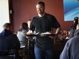 Ryan Odette of Mamo Burger in Windsor serves meals during a busy lunch time recently. The popular 80-seat restaurant does not take reservations. (DAN JANISSE / The Windsor Star)