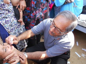 Shiva Koushik administers two drops of polio medicine to a child in Gulshan Township near the city of Karachi, Pakistan.