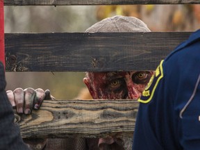 A zombie peers through a fence at a police-sponsored event in Michigan in this file photo. (Erin Kirkland / Associated Press / The Flint Journal)