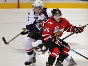 Spits captain Patrick Sanvido, left, tangles with Owen Sound Attack Petrus Palmu in first period OHL action from WFCU Centre, November 6,  2014.  (NICK BRANCACCIO/The Windsor Star)