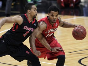 Windsor Express Gary Gibson dribbles the ball against Brampton's Anthony Harris in the first quarter at WFCU Centre Friday November 7,  2014.  (NICK BRANCACCIO/The Windsor Star)