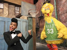 In this Dec. 9, 2013 image released by the Sesame Workshop, singer Janelle Monae, left, and character Big Bird appear in a scene from the "Power of Yet" sketch at Kaufman-Astoria Studios in the Astoria neighborhood of the Queens borough of New York.