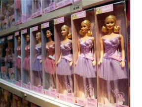 line of Barbie dolls sit on the shelf, at the Toys 'R Us Times Square flagship store in New York. (Kathy Willens/Postmedia News Service)