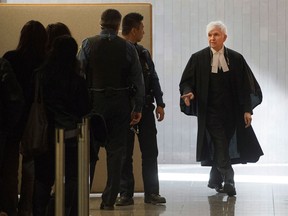 Defence lawyer Luc Leclair, right, enters the courtroom to begin his case at the murder trial for Luka Rocco Magnotta.