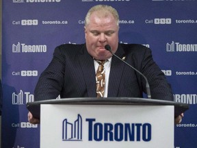 Toronto Mayor Rob Ford apologizes for crude remarks he used earlier in the day at a news conference at city hall in Toronto on Thursday, November 14, 2013. His wife Renata looks on. THE CANADIAN PRESS/Chris Young