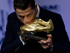 Cristiano Ronaldo kisses his Golden Boot 2014 award at Melia Castilla hotel on November 5, 2014 in Madrid, Spain. (Gonzalo Arroyo Moreno/Getty Images)