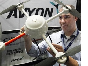 Sébastien Long from Avyon Higher solutions, gets a closer look at his company's drone on Wednesday November 05, 2014. The MD4-200 is part of the Unmanned Systems Association annual convention being held in Montreal this week. (Pierre Obendrauf / MONTREAL GAZETTE)
(Pierre Obendrauf/Postmedia News)