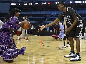 A female member of the Taraumara natives basketball team takes part in a clinic with Canada's Andrew Wiggins of the Minnesota Timberwolves at the Arena Mexico on November 11, 2014. NBA teams Minnesota Timberwolves and Houston Rockets are in Mexico to play a game next November 12.
Red paper poppies
Red paper poppies fall from the ceiling during an Armistice Day ceremony at the Menin Gate in Ypres, Belgium on Tuesday, Nov. 11, 2014. The Menin Gate Memorial bears the names of more than 54,000 British and Commonwealth soldiers who were killed in the Ypres Salient of World War I and whose graves are not known. Ovenstone’s father who served in WWI with the Royal Army was gassed and wounded on the Somme in 1915.
Members of a pipe band
Members of a pipe band walk through rows of crosses following a Remembrance Day service in Calgary, Tuesday, Nov. 11, 2014.
The sun sets behind a Turkish military
The sun sets behind a Turkish military outpost on a hill overlooking the Syrian city of Kobani, outside Suruc, on the Turkey-Syria border Tuesday, Nov.11, 2014. Kobani, also known as Ayn Arab, and its surrounding areas, has been under assault by extremists of the Islamic State group since mid-September and is being defended by Kurdish fighters.
The Camp Nelson Honor Guard
The Camp Nelson Honor Guard led a caisson for a service for World War II Navy Veterans Argyle “Pop” E. Hayner and Harvey “Harbor” J. Wills at Camp Nelson National Cemetery, in Nicholasville, Ky., Tuesday, Nov. 11, 2014. This is the last funeral for the horse pulling the caisson, Pretty Boy. The 27 year-old standardbred is retiring after eight years and 800 funerals.
The coffin of the late Zambian President Michael Sata
The coffin of the late Zambian President Michael Sata is draped in Zambias flag at the funerla in Lusaka, Tuesday, Nov, 11, 2014. Sata’s funeral was held in a stadium in the country’s capital Lusaka which was filled to capacity with hundreds more waiting outside the gates. Sata, 77, served as president of the Southern African country since 2011. He died in a London hospital on Oct. 28 after a long illness.
Newly-crowned Miss International Valerie Hernandez Matias,
Newly-crowned Miss International Valerie Hernandez Matias, center, of Puerto Rico waves with her runners-up, from left, third runner-up Victoria Charlotte Tooby of Great Britain, first runner-up Zuleika Suarez of Colombia, second runner-up Punika Kulsoontornrut of Thailand and forth runner-up Milla Romppanen of Finland, after the final of Miss International Beauty Pageant in Tokyo Tuesday, Nov. 11, 2014.
A goat looks through a hole
A goat looks through a hole in the wall in the village of Caykara, Turkey, on the Turkey-Syria border, just across from Kobani, Tuesday Nov. 11, 2014. Kobani, also known as Ayn Arab, and its surrounding areas, has been under assault by extremists of the Islamic State group since mid-September and is being defended by Kurdish fighters.
Street performer John Casey
Street performer John Casey, wearing silver paint as part of his act as “The Silver Cowboy of Nashville,” watches the Veterans Day parade pass by Tuesday, Nov. 11, 2014, in Nashville, Tenn.
A yellow rose
A yellow rose stands wedged into the name of Richard Rescorla at the South Pool of the National September 11 Memorial, Tuesday, Nov. 11, 2014, in New York. Volunteers placed yellow roses into the names of veterans who died at the World Trade Center on September 11 as part of a five-day Salute to Service in recognition of Veterans Day. Rescorla, a Vietnam veteran and vice president in charge of security at Morgan Stanley Dean Witter, was killed on September 11.
Palestinians carry the body of Mohammed Jwabreh
Palestinians carry the body of Mohammed Jwabreh, 21, during his funeral in al-Aroub refugee camp, near the West Bank town of Hebron, Tuesday, Nov. 11, 2014. Jwabreh was hit by a live bullet in the chest in clashes with Israeli security forces Tuesday.
Myanmar farmers
Myanmar farmers winnow paddy close to Myanmar International Convention Center, the venue of the 25th Association of Southeast Asian Nations (ASEAN) summit in Naypyitaw, Myanmar, Tuesday, Nov. 11, 2014. Myanmar hosts the ASEAN summit and related meetings on Nov. 12 and 13.
Maddie Nistl
Maddie Nistl, 9, walks with her father, Dee Nistl, an Air Force veteran, past flag-covered graves placed for Veterans Day in the veterans’ section of Evergreen-Washelli cemetery, Tuesday, Nov. 11, 2014, in Seattle. Maddie has come to the cemetery every Veterans Day and Memorial Day since she was three years old to place roses on the graves of veterans. The Veterans Day holiday honors people who have served in the U.S. Armed Forces and marks the anniversary of the end of World War I, which formally ended at the 11th hour of the 11th day of the 11th month in 1918.
Yellow roses
Yellow roses stand wedged into names carved in the granite at the South Pool of the National September 11 Memorial, Tuesday, Nov. 11, 2014, in New York. Volunteers placed yellow roses into the names of veterans who died during the attacks on September 11 as part of a five-day Salute to Service in recognition of Veterans Day.
Peter Moses
Peter Moses, of Fort Collins, walks his dog, Ziggy, a 7-month-old yellow lab, in her first snowfall at Troutman Park, early Tuesday, Nov. 11, 2014, in Fort Collins, Colo. Temperatures aren’t expected to get out of the teens in parts of eastern Colorado thanks to the remnants of a powerful storm that hit Alaska over the weekend.
Anna Mansfield
Anna Mansfield wears sneakers decorated like the American flag as she attends a Veterans Day ceremony at the Atlanta History Center, Tuesday, Nov. 11, 2014, in Atlanta.
Lima
A man looks at the Pacific Ocean late afternoon in Lima, Peru, Sunday, Nov. 9, 2014.
Mercedes driver Nico Rosberg
Mercedes driver Nico Rosberg , center, of Germany leads the field away from the starting grid the Formula One Brazilian Grand Prix at the Interlagos race track in Sao Paulo, Brazil, Sunday, Nov. 9, 2014. Rosberg of Germany, fended off a strong charge by Lewis Hamilton to win the Brazilian Grand Prix on Sunday, closing in on his Mercedes teammate in the Formula One title race.
Green Bay Packers tight end Brandon Bostick (86)
Green Bay Packers tight end Brandon Bostick (86) celebrates a touchdown with fans during the first half of an NFL football game against the Chicago Bears on Sunday, Nov. 9, 2014, in Green Bay, Wis.
Journalists visit the Sphinx
Journalists visit the Sphinx on a media tour following the completion of restoration work in preparation for the reopening of the courtyard around its base, in Giza, near Cairo, Egypt, Sunday, Nov. 9, 2014.
Catalonia’s regional president Artur Mas
Catalonia’s regional president Artur Mas arrives surrounded of media following an informal poll for the independence of Catalonia in Barcelona, Spain, Sunday, Nov. 9, 2014. Catalonia’s government said more than a million voters participated Sunday in an informal vote on whether the wealthy northeastern region should secede from the rest of Spain. The regional Catalan government pushed forward with the vote despite Spain’s Constitutional Court ordering its suspension on Tuesday after it agreed to hear the Spanish government’s challenge that the poll is unconstitutional.
Berlin Wall
Balloons of the light installation Lichtgrenze sail into the night from the former route of the Berlin Wall during a Street Party organized by German governement to mark the 25th anniversary of the fall of the Berlin Wall, in front of the Brandenburg Gate on November 9, 2014 in Berlin.
Britain
Britain's Prime Minister David Cameron lays a poppy in the field of poppies at The Tower of London, Saturday Nov. 8, 2014. The poppies are part of a ceramic poppy installation called 'Blood Swept Lands and Seas of Red' which marks the centenary of the outbreak of the First World War.
Hong Kong
A rainbow umbrella is placed during a gay rally in Hong Kong Saturday, Nov. 8, 2014. Thousands of people took part in the annual Gay Pride Parade including representatives from the mainland and Taiwan.
Tokyo
A Buddhist monk walks in the rain at Sensoji Buddhist temple at Asakusa district in Tokyo, Saturday, Nov. 8, 2014. Asakusa is an old town in the capital that draws many tourists from across the world.
Philippines
Survivors release floating lanterns Saturday, Nov. 8, 2014 at Tacloban city, Leyte province in central Philippines. Church bells pealed and sirens blared across this central Philippine city Saturday to commemorate the moment when Haiyan barreled inland from the Pacific with ferocious winds and tsunami-like waves, leaving more than 7,300 dead or missing and leveling entire villages in the world's deadliest disaster last year.
Ukraine
Unmarked military vehicles parked on a road outside the separatist rebel-held eastern Ukrainian town of Snizhne, 80 kilometers (50 miles) from Donetsk on Saturday Nov. 8, 2014. AP reporters saw more than 80 military vehicles on the move Saturday in separatist-controlled areas, indicating intensified hostilities may lie ahead.
Sgt. Rylan Betker
Sgt. Rylan Betker at the armoury in Regina on Nov 06, 2014.
Spectators pack on the Tonle Sap
Spectators pack on the Tonle Sap river bank watch a boat race in front of Royal Palace in Phnom Penh, Cambodia, Friday, Nov. 7, 2014 during the the annual water festival. The three-day festival, started Wednesday, dedicates to the kingdom’s ancestral naval warriors.
Models
Models wear creations from the Acquastudio Winter collection during the Sao Paulo Fashion Week in Sao Paulo, Brazil, Friday, Nov. 7, 2014.
Supporters of Yemen’s ousted President Ali Abdullah Saleh
Supporters of Yemen’s ousted President Ali Abdullah Saleh, shown on a picture, center, chant slogans to express their rejection of U.S. Ambassador Matthew H. Tueller during a demonstration against foreign interference in Sanaa, Yemen, Friday, Nov. 7, 2014. Thousands of supporters of Yemen’s ousted president and Shiite rebels who have overrun the capital rallied in Sanaa, denouncing what they claim to be American “interference” in Yemen’s affairs.
Pro independence
Pro independence supporters take part in a rally ahead of voting on an informal poll, scheduled for next Sunday, in Barcelona, Spain, on Friday Nov. 7, 2014. The pro-independence regional government of Catalonia stages a symbolic poll on secession in a show of determination and defiance after the Constitutional Court suspended its plans to hold an official independence referendum following a legal challenge by the Spanish government.
Fire Dept. of New York Battalion
Fire Dept. of New York Battalion Chief Greg Hansson places flags in the names of first responders, who were military veterans, during a special five-day Salute to Service, at The National September 11 Memorial, in New York, Friday, Dec. 3, 2014.
A Palestinian uses a sling shot
A Palestinian uses a sling shot during clashes with Israeli forces following a protest against Israeli restrictions to Al-Aqsa Mosque in Jerusalem, at Qalandia checkpoint near the West Bank city of Ramallah, Friday, Nov. 7, 2014.
A tram driver
A tram driver steers a 28 line tram in downtown Lisbon, Portugal, Friday, Nov. 7, 2014. The 28 line has become a very frequented ride by tourists due to its tour along difference popular areas.
A girl holds a doll
A girl holds a doll as refugees wait for the funeral convoy of 19 year-old Syrian Kurdish fighter girl Perwin Mustafa Dihap who died after being wounded during fighting against the Islamic State forces in her home town of Kobani, to pass by the camps in Suruc, on the Turkey-Syria border Friday, Nov. 7, 2014. Kobani, also known as Ayn Arab, and its surrounding areas, has been under assault by extremists of the Islamic State group since mid-September and is being defended by Kurdish fighters.
A Chinese child holds a Chinese national flag
A Chinese child holds a Chinese national flag near Tiananmen Gate in Beijing, China, Friday, Nov. 7, 2014. Despite earlier estimates that new exemptions to China’s one-child policy would add up to 2 million extra births per year, only 700,000 newly qualified couples applied to have a second child this year, a Chinese official said this week.
Relatives of 14-year-old Daniil Kuznetsov
Relatives of 14-year-old Daniil Kuznetsov stand at his coffin during funeral at a local cemetery in Donetsk, eastern Ukraine, Friday, Nov. 7, 2014. The rebel stronghold of Donetsk on Friday mourned the two teenagers who were killed in Wednesday’s artillery strike on a high school on the city’s western outskirts.