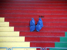 Afghan women sit in the rafters as they watch girls compete in a Taekwon-Do match in Herat on November 13, 2014. Women were banned from participating in sports by the then-ruling Taliban regime, that was forced from power in 2001, as part of a raft of measures that kept women uneducated and out of the public domain. AFP PHOTO / Aref KARIMIAref Karimi/AFP/Getty Images