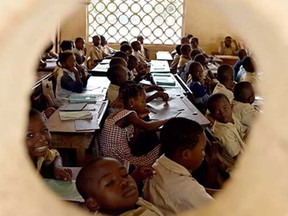 Schoolchildren sit in their classroom at a primary school in Bouake, central Ivory Coast, on October 23, 2014.