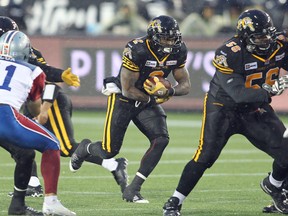 Nic Grigsby #2 of the Hamilton Tiger-cats runs the ball against the Montreal Alouettes in a CFL football game at Tim Hortons Field on November 8, 2014 in Hamilton, Ontario, Canada. (Photo by Claus Andersen/Getty Images)