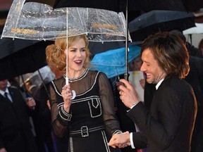 Actress Nicole Kidman and singer Keith Urban hold hands as they pose for photographers upon arrival at the world premiere of the film Paddington in London, Sunday, Nov. 23, 2014.
