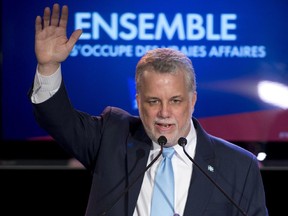 Quebec Liberal Leader Philippe Couillard waves to supporters during his victory speech, Monday, April 7, 2014 in St-Felicien, Que. Quebecers voted for a Liberal majority government. THE CANADIAN PRESS/Jacques Boissinot