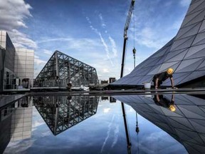 Window cleaners work at the construction of the "Musee des Confluences" science centre and anthropology museum in Lyon on October 14, 2014 ahead of its December opening.