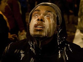 A protestor pours milk in his eyes after being tear gassed by Seattle police at the Interstate 5 entrance on Cherry Street in Seattle, Monday, Nov. 24, 2014. Protestors took to the streets in response to the Ferguson, Mo., grand jury decision not to indict Officer Darren Wilson in the death of Michael Brown.