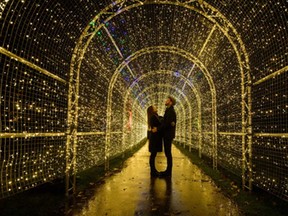 Miranda Jenatka (L) and Alex Little pose for photographs during the launch event of the "Christmas at Kew" lights in Kew Gardens in southwest London on November 25, 2014.