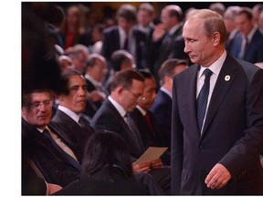 Russia's President Vladimir Putin (R) arrives as (L-R) Canada's Prime Minister Stephen Harper and US President Barack Obama look on during the G20 Summit "welcome country" ceremony at the Brisbane Convention and Exhibition Center on November 15, 2014 in Brisbane. Australia is hosting the leaders of the world's 20 biggest economies for the G20 summit in Brisbane on November 15 and 16. (Postmedia News files)