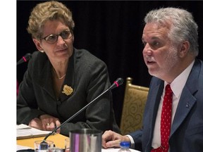Ontario Premier Kathleen Wynne and Quebec Premier Philippe Couillard chair a joint cabinet meeting at the Ontario Legislature in Toronto on Friday, November 21, 2014.
Photograph by: Chris Young , Calgary Herald