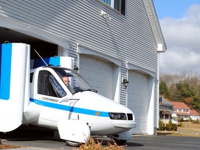 The Terrafugia Transition emerges from a garage. More than a hundred people have paid deposits of $10,000 each for the Transition, which will be capable of 70 miles (110 kilometers) per hour on the road and 100 mph in the sky when it finally comes to market sometime within the next three years. Illustrates FLYING-CAR (category a) by Josh Dean (c) 2014, Bloomberg News. Moved Saturday, Nov. 29, 2014 (MUST CREDIT: Terrafugia).