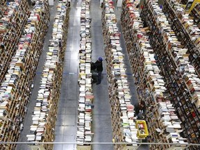 Amazon.com employees work the shelves along the miles of aisles at an Amazon.com Fulfillment Center on "Cyber Monday", the Monday after Thanksgiving and the busiest online shopping day of the holiday season, in Phoenix. Millions of Americans are expected to log on and keep shopping on Monday, Dec. 1, 2014, the day dubbed Cyber Monday. (AP Photo/Ross D. Franklin, File)