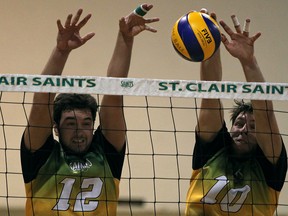 Lakeshore's Curtis Loch, left, and Kingsville's Travis Wigle block a spike for St. Clair against the Sheridan Bruins during OCAA men's volleyball. (DAX MELMER/The Windsor Star)
