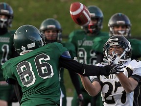 General Amherst's Douglas Leake, right, makes a catch in front of Lajeunesse's Jerry Kabula at Alumni Field Thursday. (TYLER BROWNBRIDGE/The Windsor Star)