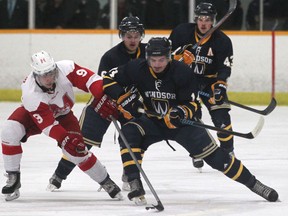 Windsor's Julian Luciani, right, battles McGill's Max Le Sieur, left, for the puck at South Windsor Arena. (DAX MELMER/The Windsor Star)