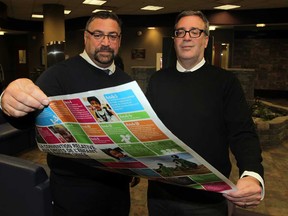 CAS director of children services Lyle Ward, left, and Irwin Elman, Office of the Provincial Advocate for Children and Youth review rights of children literature in the front lobby of CAS Windsor on Riverside Drive East Monday November 17, 2014. (NICK BRANCACCIO/The Windsor Star)