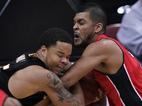 Windsor Express Kevin Loiselle wrestles for rebound with London Lightning Johnathan Mills in NBL Canada league action from WFCU Centre Wednesday November 19, 2014. (NICK BRANCACCIO/The Windsor Star)