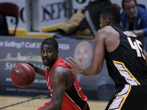 Windsor's Tony Bennett, left, is guarded by London's Marvin Phillips Wednesday at the WFCU Centre Wednesday. (NICK BRANCACCIO/The Windsor Star)