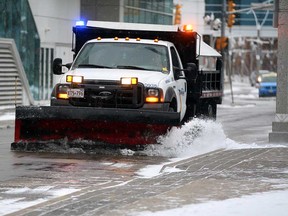 First snowfall of the fall/winter seasons resulted in many City of Windsor snow plows on city streets like this one on Chatham Street East near Caesars Windsor and Superior Court of Justice Wednesday November 19, 2014. (NICK BRANCACCIO/The Windsor Star)