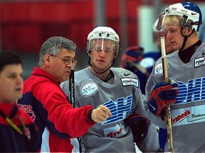 Spitfires coach Tom Webster, left, talks with forward Steve Hildenbrand, centre, during practice at Windsor Arena in 2001. (DAN JANISSE/The Windsor Star)
