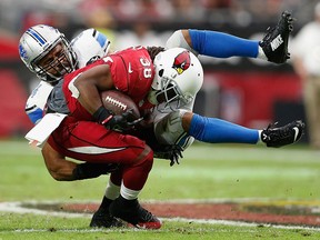 Running back Andre Ellington #38 of the Arizona Cardinals is tackled by outside linebacker DeAndre Levy #54 of the Detroit Lions in the first quarter during the NFL game at the University of Phoenix Stadium on November 16, 2014 in Glendale, Arizona. (Photo by Christian Petersen/Getty Images)