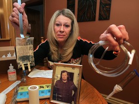 Peggy Hoover displays some of the medical apparatus she uses to treat her husband Tom Wherrit, 63, at home Monday November 24, 2014. Stricken with a serious bone infection, Wherrit must take daily intravenous antibiotics and dozens of heart and diabetes related medications. (NICK BRANCACCIO/The Windsor Star)
