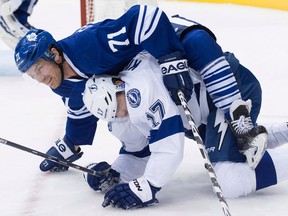 Toronto's David Clarkson, left, gets tangled up with Tampa Bay's Alex Killorn during the first period in Toronto. (THE CANADIAN PRESS/Darren Calabrese)