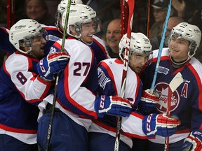 Windsor's Slater Doggett, right, celebrates his second goal of the game with teammates Trevor Murphy, from left, Hayden McCool, Logan Brown, behind, and Sam Povorozniouk against Sarnia at the WFCU Centre. (NICK BRANCACCIO/The Windsor Star)