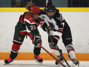 Windsor's leading scorer Savannah Bouzide, right, is checked by London's Grace Donaldson during their Provincial Women's Hockey League game at Forest Glade Arena. (DAN JANISSE/The Windsor Star)