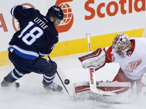 Detroit goaltender Petr Mrazek, right, stops Winnipeg's Bryan Little Thursday in Winnipeg. (THE CANADIAN PRESS/John Woods)