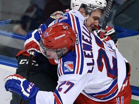 Windsor's Liam Murray, left, is hit by Kitchener's Darby Llewellyn during the first period at the Kitchener Memorial Auditorium Friday. (DAVID BEBEE/Kitchener-Waterloo Record)