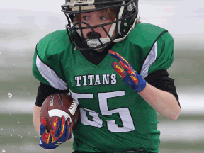 The Titans' Liam Carlone carries the football during the Day of Champions at Alumni Field Saturday. (DAN JANISSE/The Windsor Star)