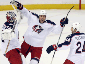 Kingsville's Dalton Prout, centre, celebrates with Columbus goalie Sergei Bobrovsky, left, and Derek MacKenzie after the Blue Jackets beat the Minnesota Wild 2-1 in a shootout. (AP Photo/Jim Mone)